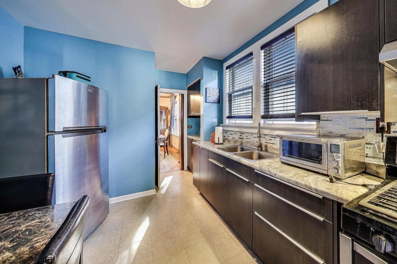 8346 South Aberdeen Street Chicago, IL 60620 - Photo 14 of 26 a kitchen with stainless steel appliances granite countertop a refrigerator a sink and a stove