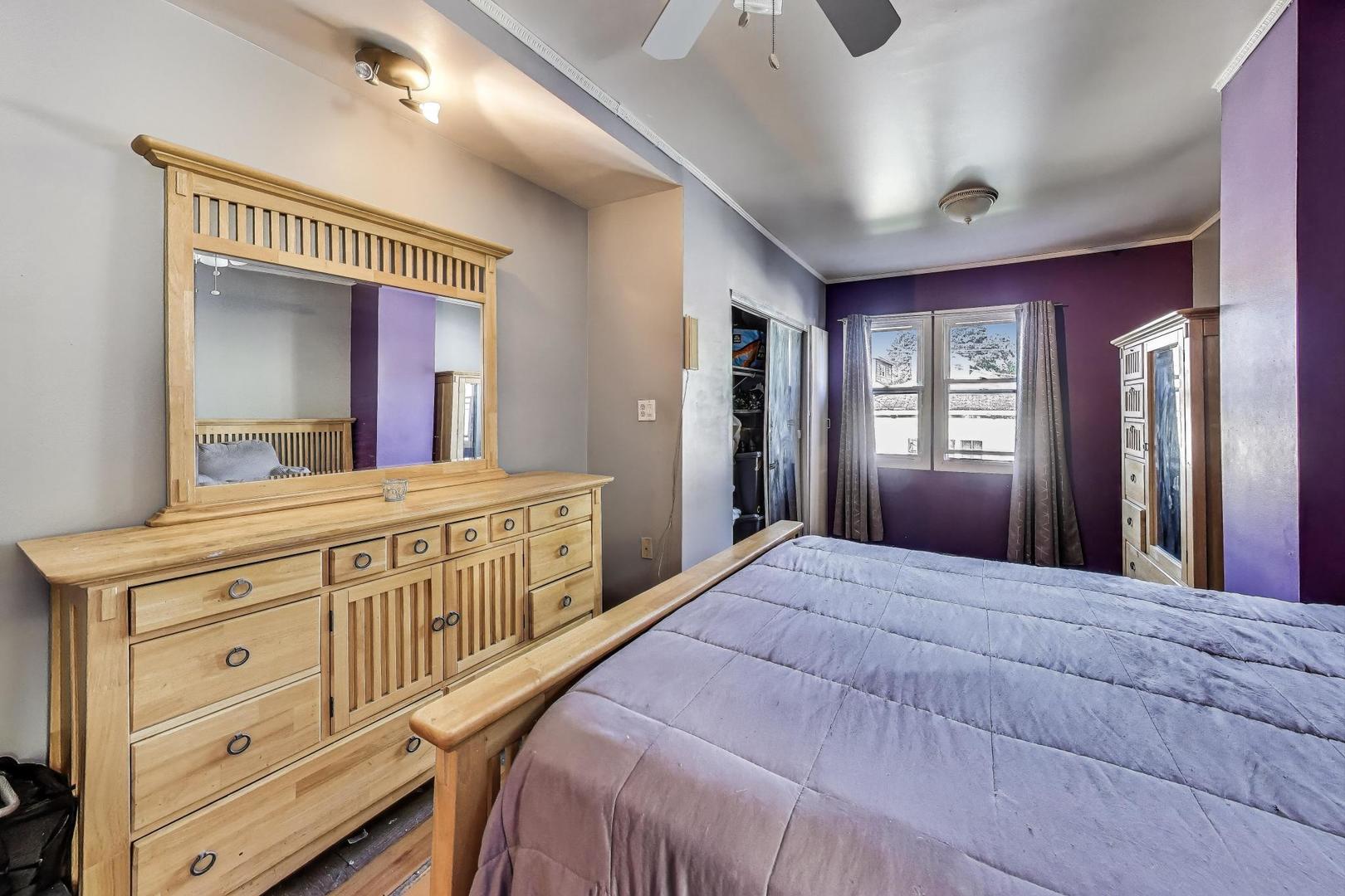 8346 South Aberdeen Street Chicago, IL 60620 - Photo 16 of 26 a bedroom with a large bed and a dresser