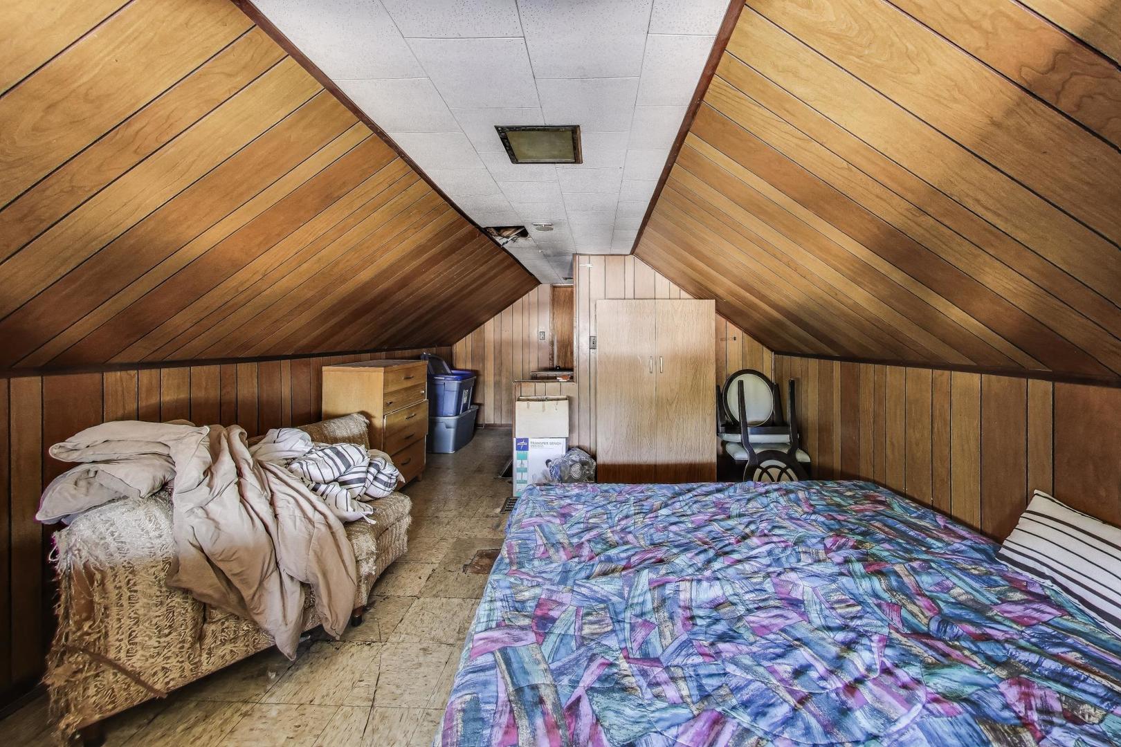 8346 South Aberdeen Street Chicago, IL 60620 - Photo 22 of 26 a bed sitting in a bedroom next to a window