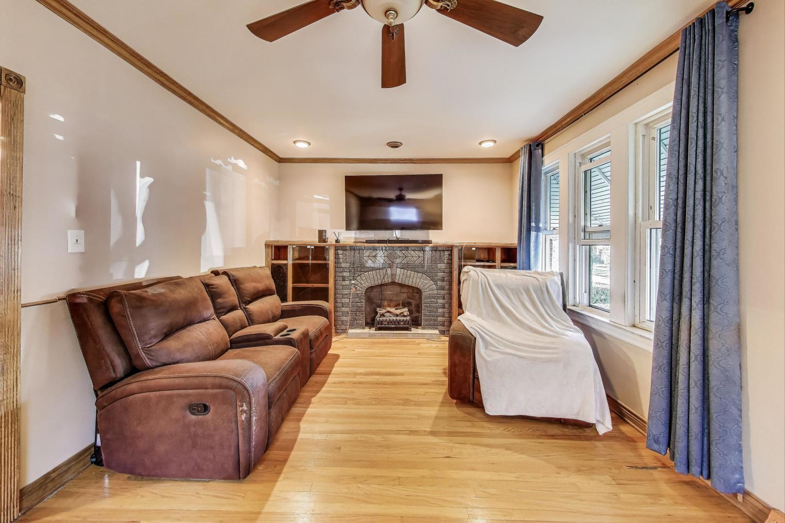 8346 South Aberdeen Street Chicago, IL 60620 - Photo 8 of 26 a living room with furniture and a fireplace