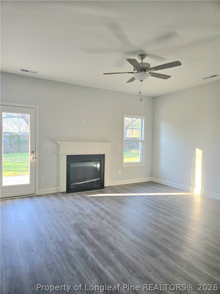 1354 East Manchester Road Spring Lake, NC 28390 - Photo 3 of 15 a view of an empty room with a window and wooden floor
