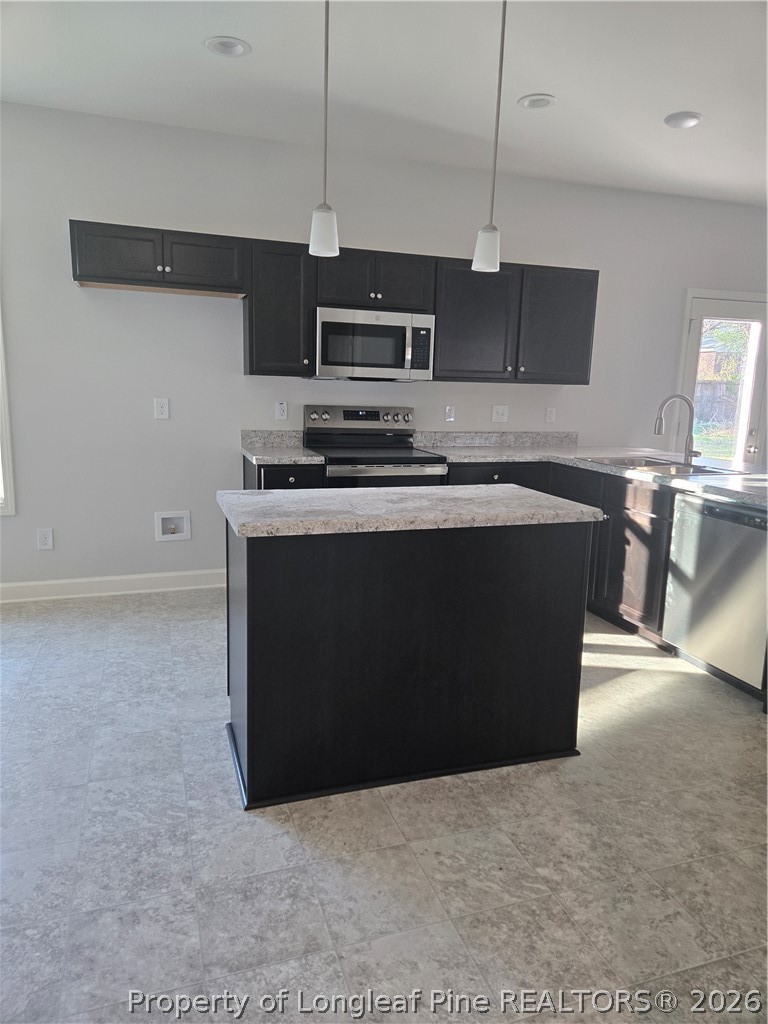 1354 East Manchester Road Spring Lake, NC 28390 - Photo 4 of 15 a kitchen with stainless steel appliances granite countertop a stove a sink and a microwave