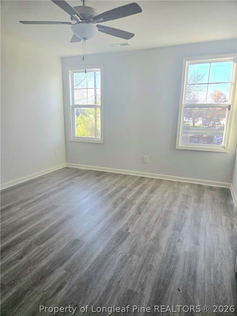 1354 East Manchester Road Spring Lake, NC 28390 - Photo 5 of 15 an empty room with wooden floor and windows