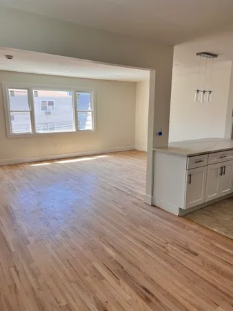 a view of a kitchen with wooden floor
