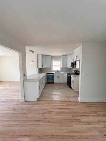 a view of kitchen and wooden floor