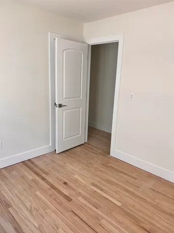 a view of a room with wooden floor