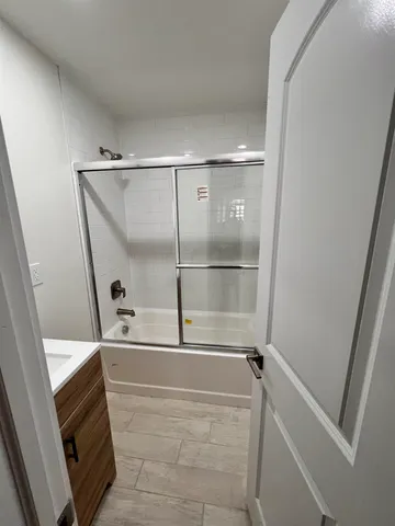 a bathroom with a tub and shower
