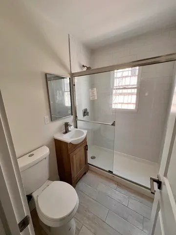 a white toilet sitting next to a bathroom sink