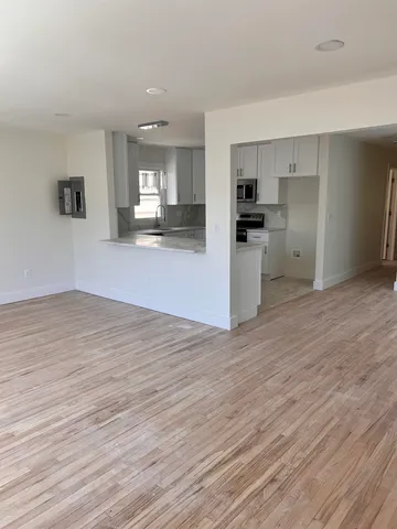 a view of kitchen with cabinets and wooden floor