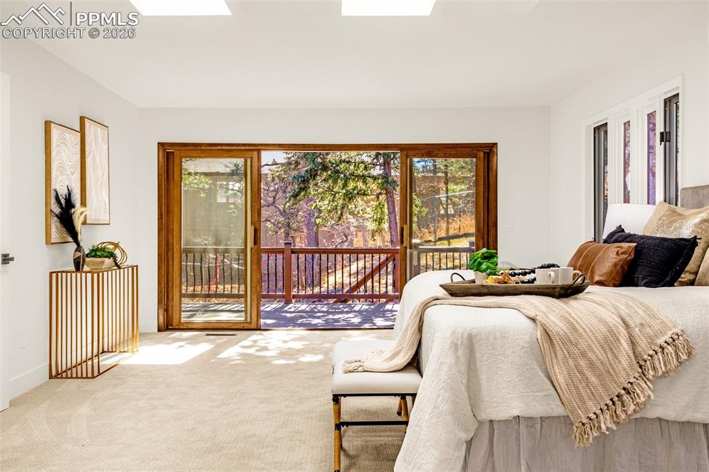 26 Leaming Road Colorado Springs, CO 80906 - Photo 26 of 45 a spacious bedroom with a bed and a large window