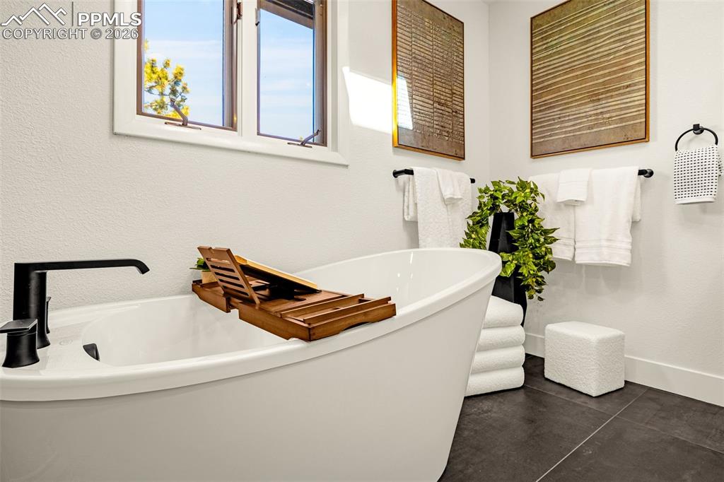 26 Leaming Road Colorado Springs, CO 80906 - Photo 32 of 45 a white bath tub sitting next to a white sink