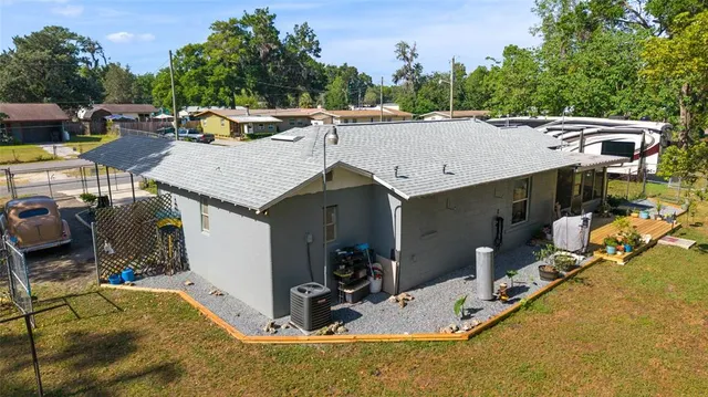 a view of a house with backyard porch and sitting area