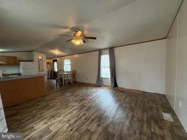 a view of a livingroom with furniture and a kitchen