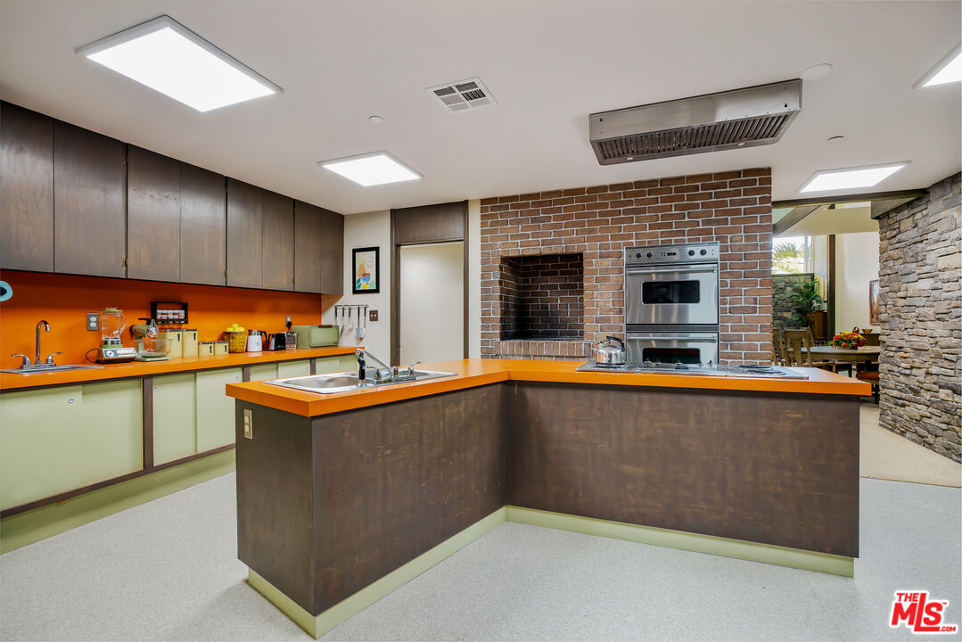 11222 Dilling Street Studio City, CA 91602 - Photo 11 of 30 a kitchen with stainless steel appliances granite countertop a sink and stove