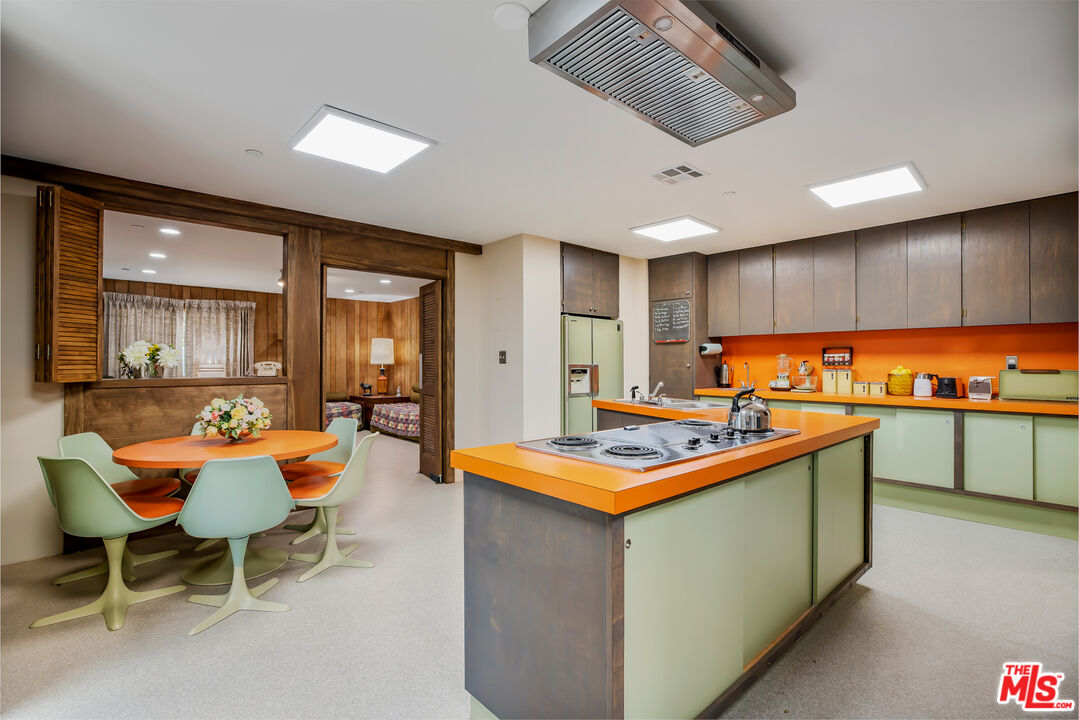 11222 Dilling Street Studio City, CA 91602 - Photo 12 of 30 a kitchen with stainless steel appliances granite countertop sink stove and wooden cabinets