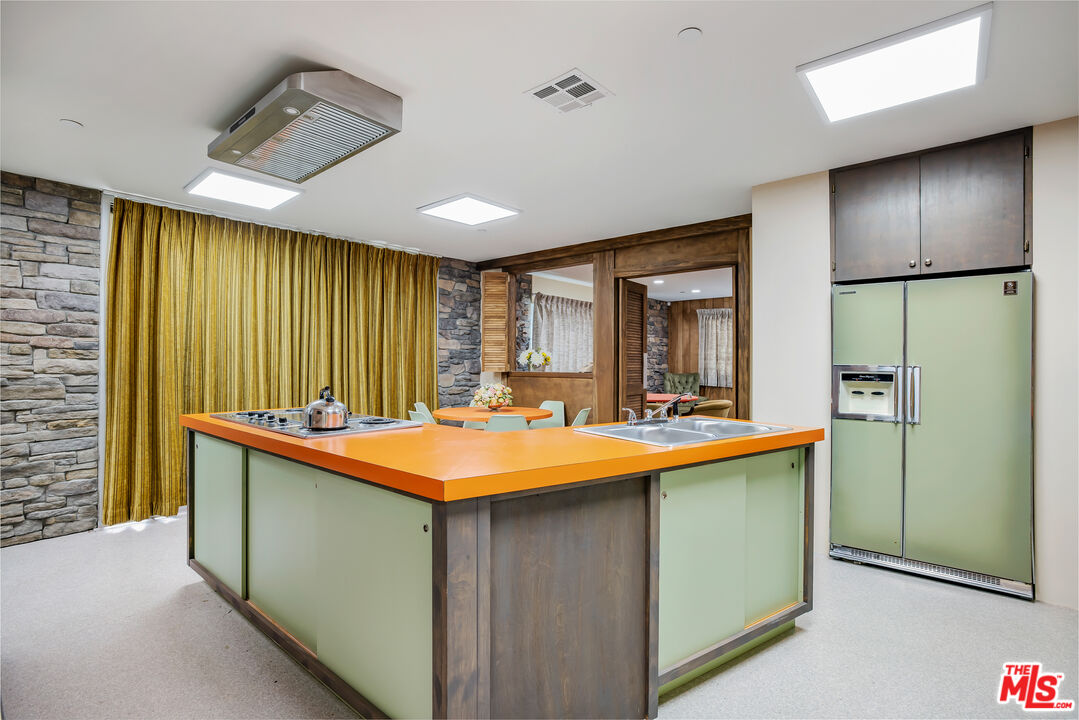 11222 Dilling Street Studio City, CA 91602 - Photo 13 of 30 a room with stainless steel appliances granite countertop furniture a sink and a refrigerator