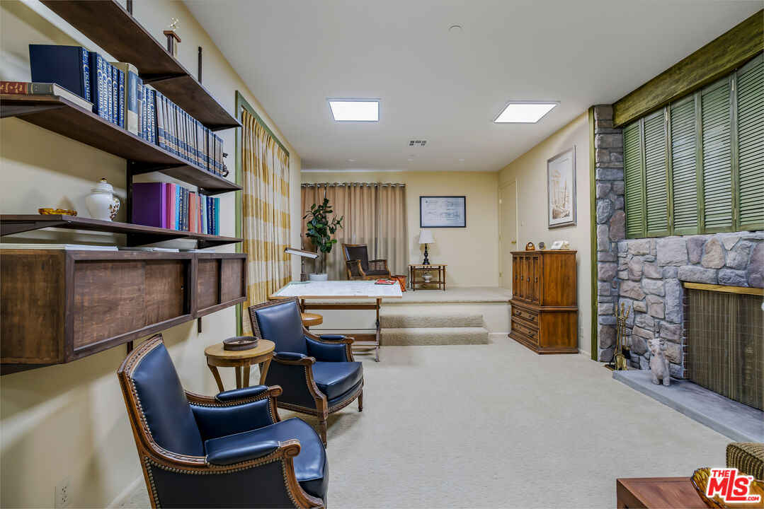 11222 Dilling Street Studio City, CA 91602 - Photo 15 of 30 a living room with furniture a fireplace and a large window