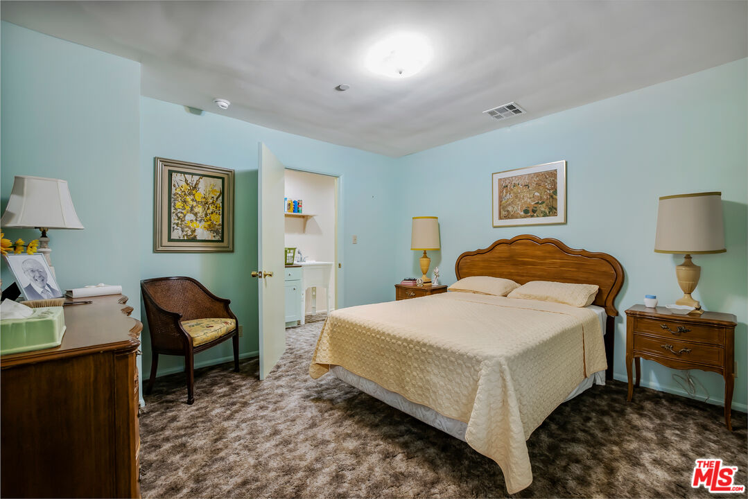 11222 Dilling Street Studio City, CA 91602 - Photo 22 of 30 a bedroom with a bed and a chair in it