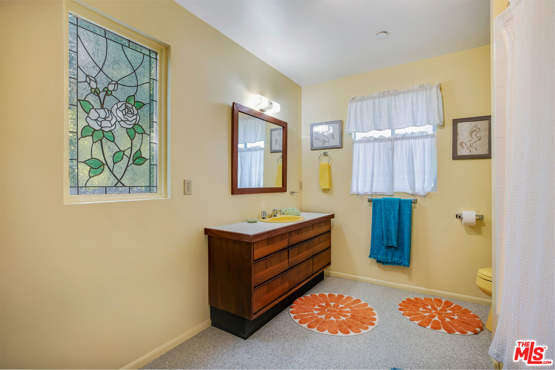 11222 Dilling Street Studio City, CA 91602 - Photo 23 of 30 a bathroom with a sink and a mirror