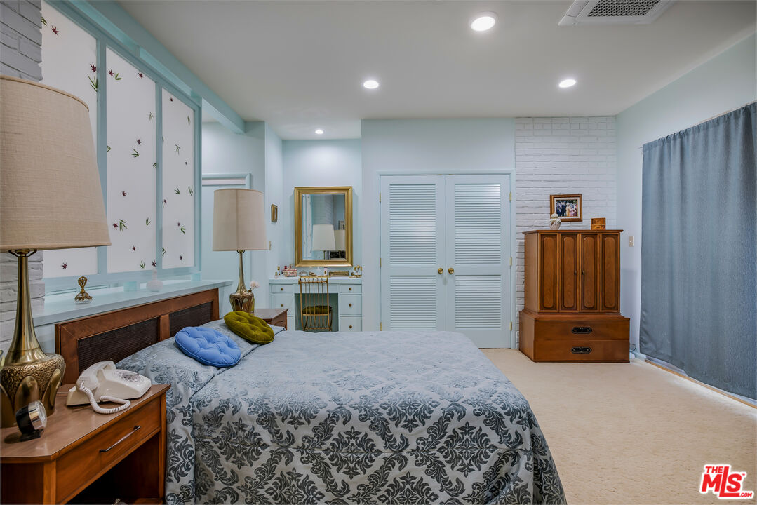 11222 Dilling Street Studio City, CA 91602 - Photo 24 of 30 a bedroom with a bed and furniture