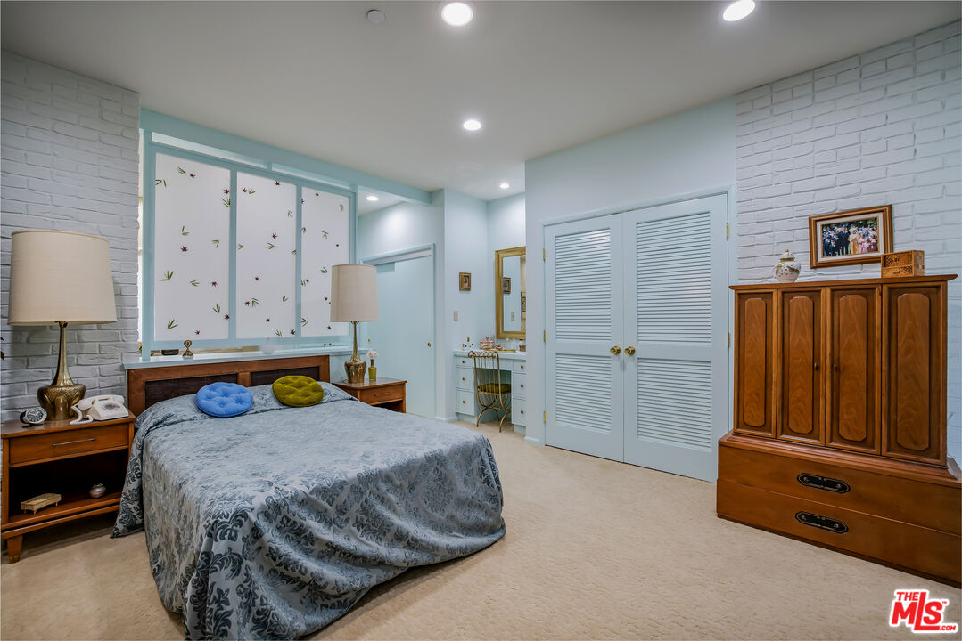 11222 Dilling Street Studio City, CA 91602 - Photo 25 of 30 a bedroom with a bed and a table