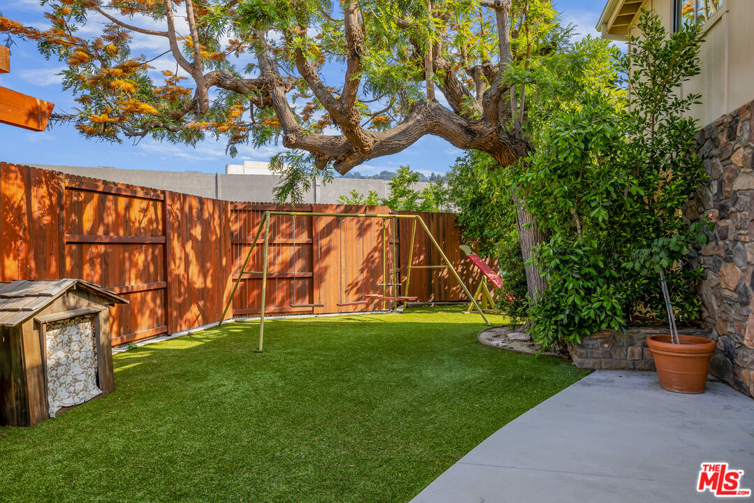 11222 Dilling Street Studio City, CA 91602 - Photo 29 of 30 a view of a backyard with potted plants and a large tree