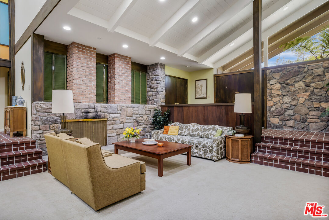 11222 Dilling Street Studio City, CA 91602 - Photo 3 of 30 a living room with fireplace furniture and a floor to ceiling window