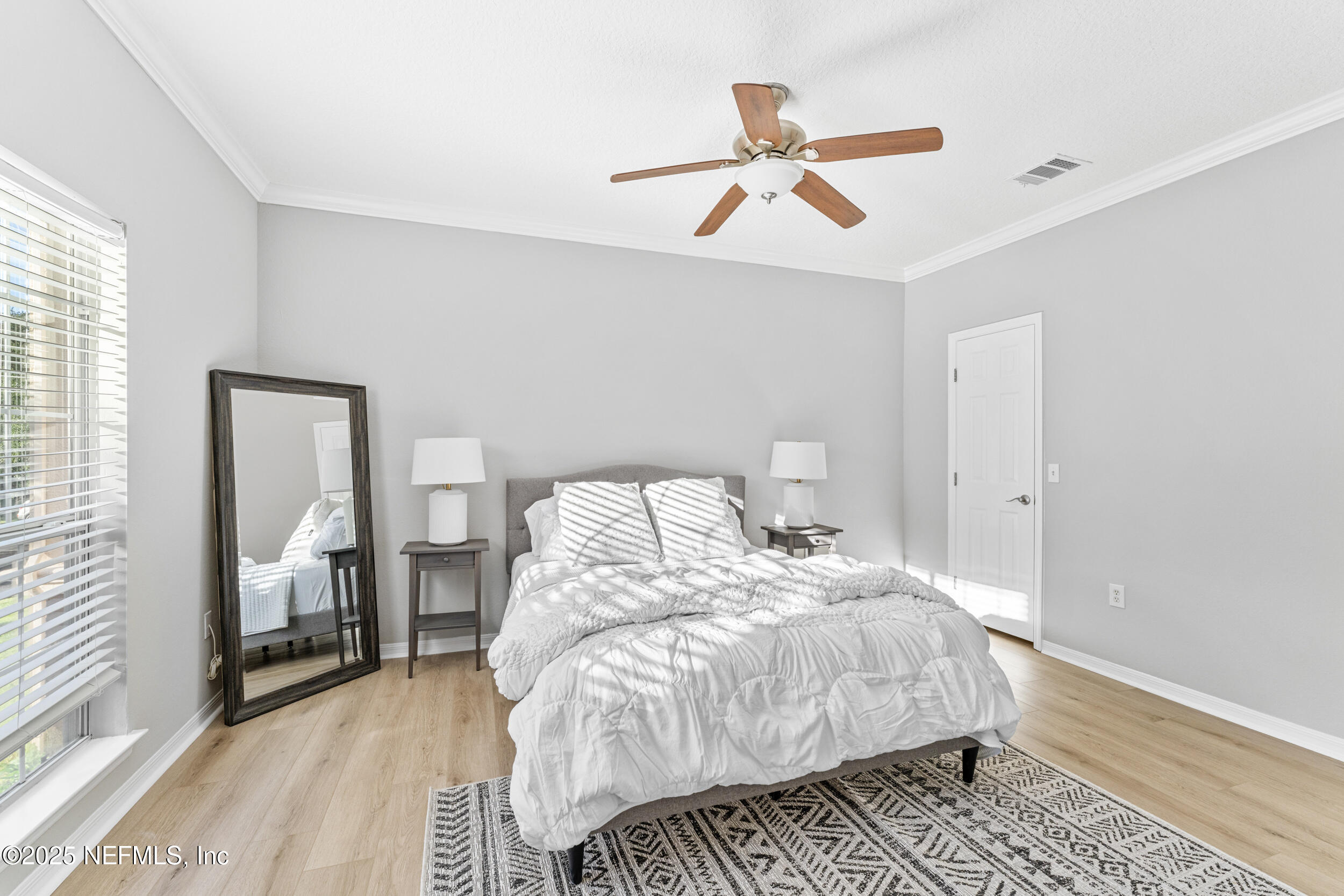 10961 Burnt Mill Road, Unit 621 Jacksonville, FL 32256 - Photo 11 of 19 a bed room with a bed and a ceiling fan