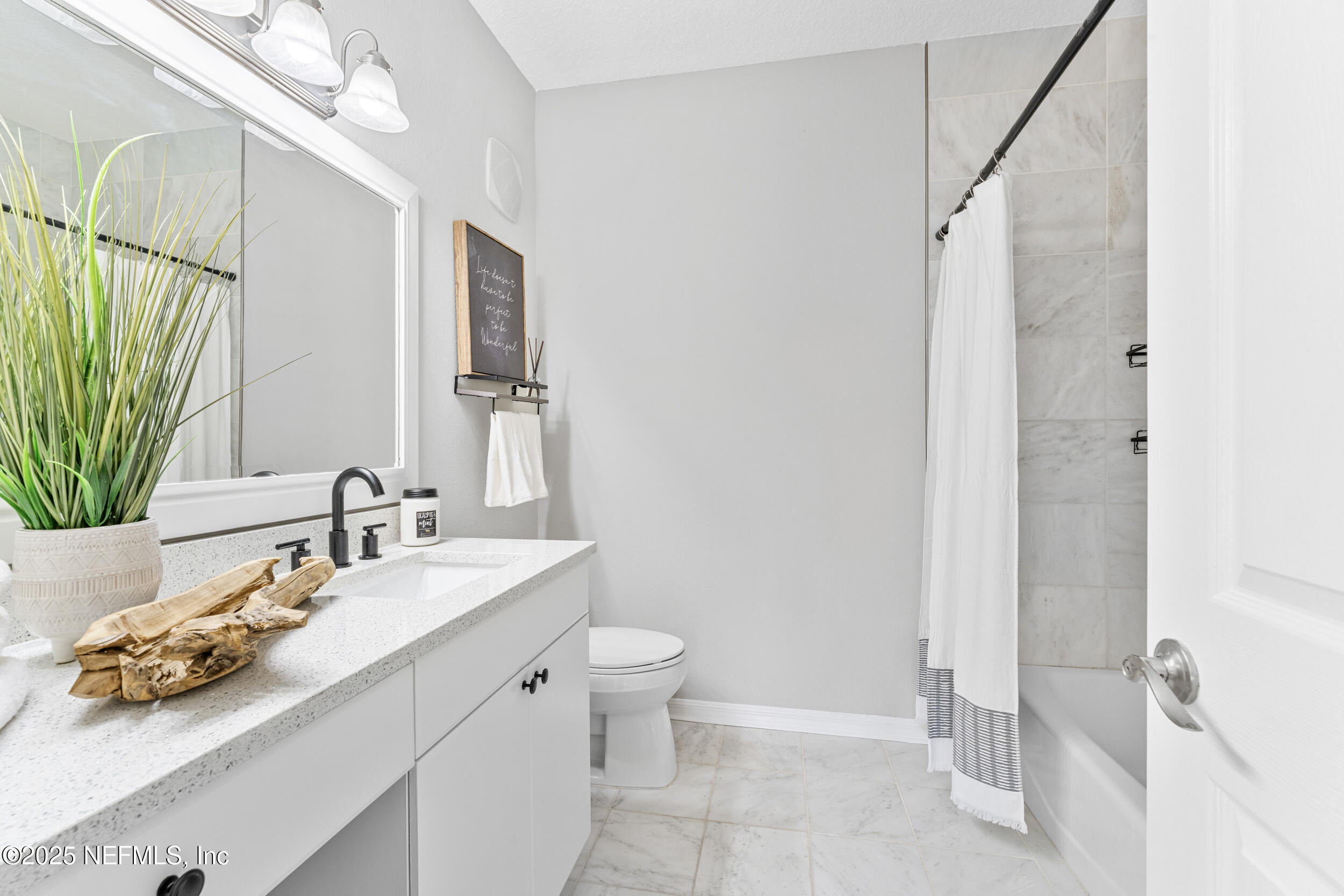 10961 Burnt Mill Road, Unit 621 Jacksonville, FL 32256 - Photo 12 of 19 a bathroom with a sink a toilet and a mirror