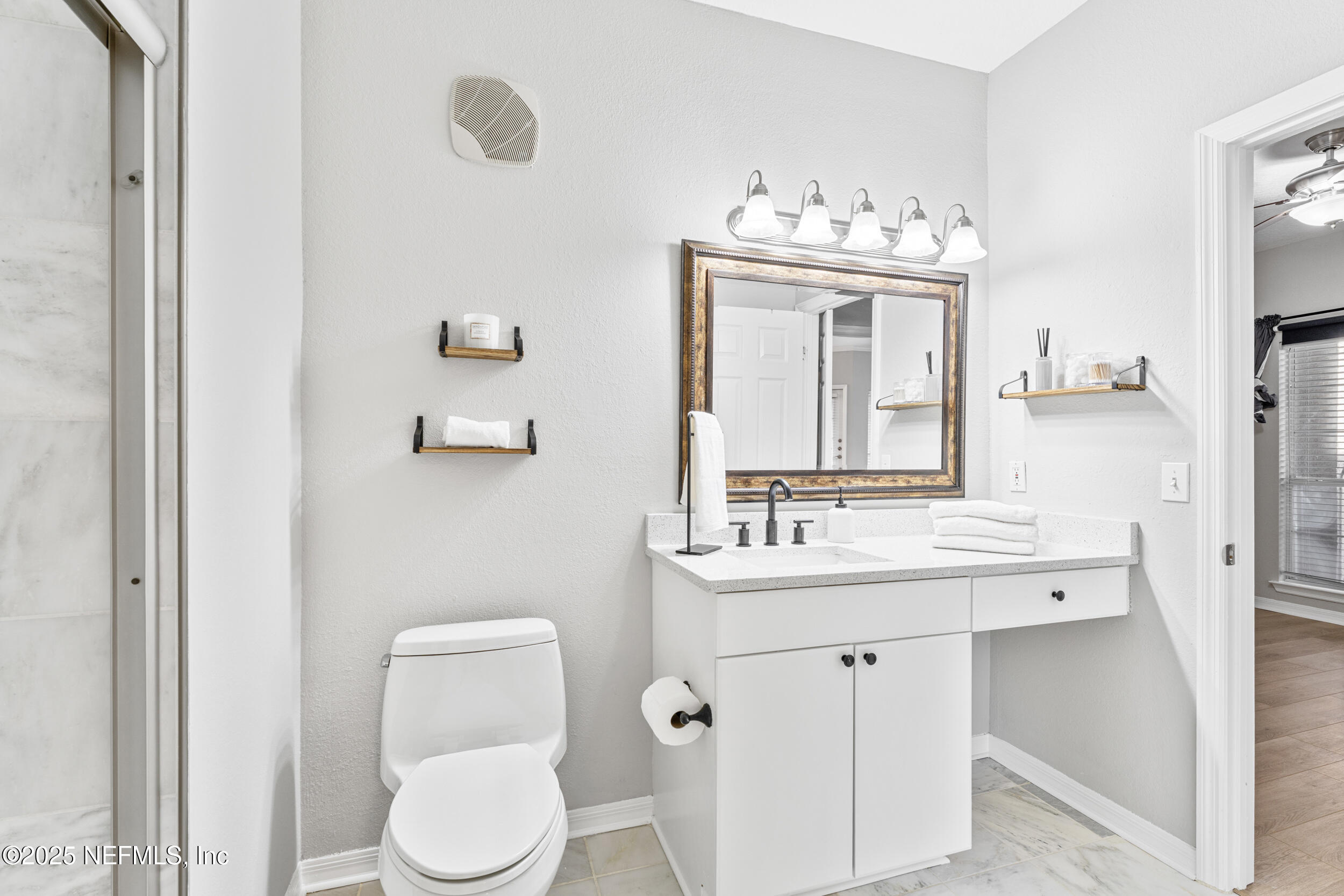 10961 Burnt Mill Road, Unit 621 Jacksonville, FL 32256 - Photo 13 of 19 a bathroom with a toilet sink and mirror