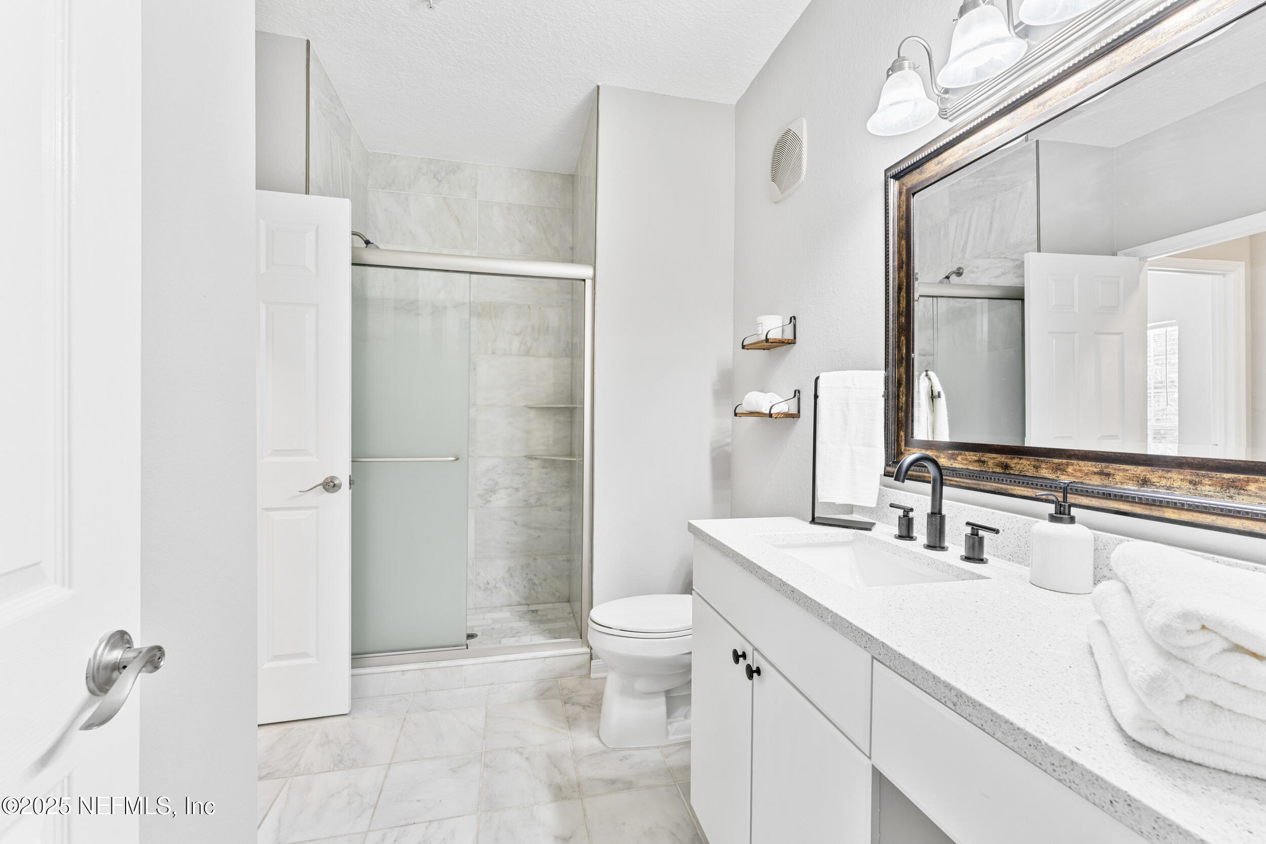 10961 Burnt Mill Road, Unit 621 Jacksonville, FL 32256 - Photo 14 of 19 a bathroom with a sink a toilet and shower