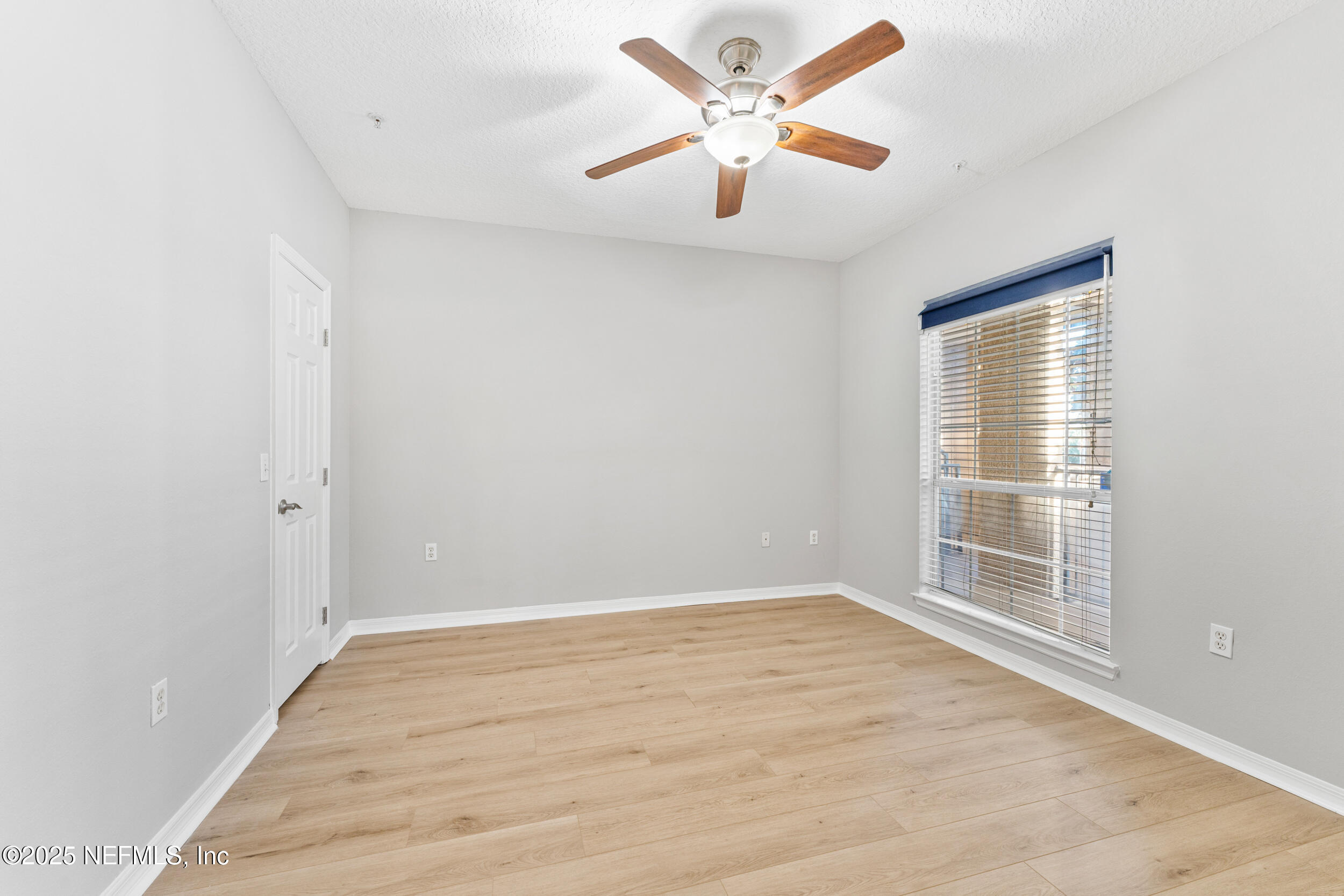 10961 Burnt Mill Road, Unit 621 Jacksonville, FL 32256 - Photo 15 of 19 an empty room with wooden floor and windows