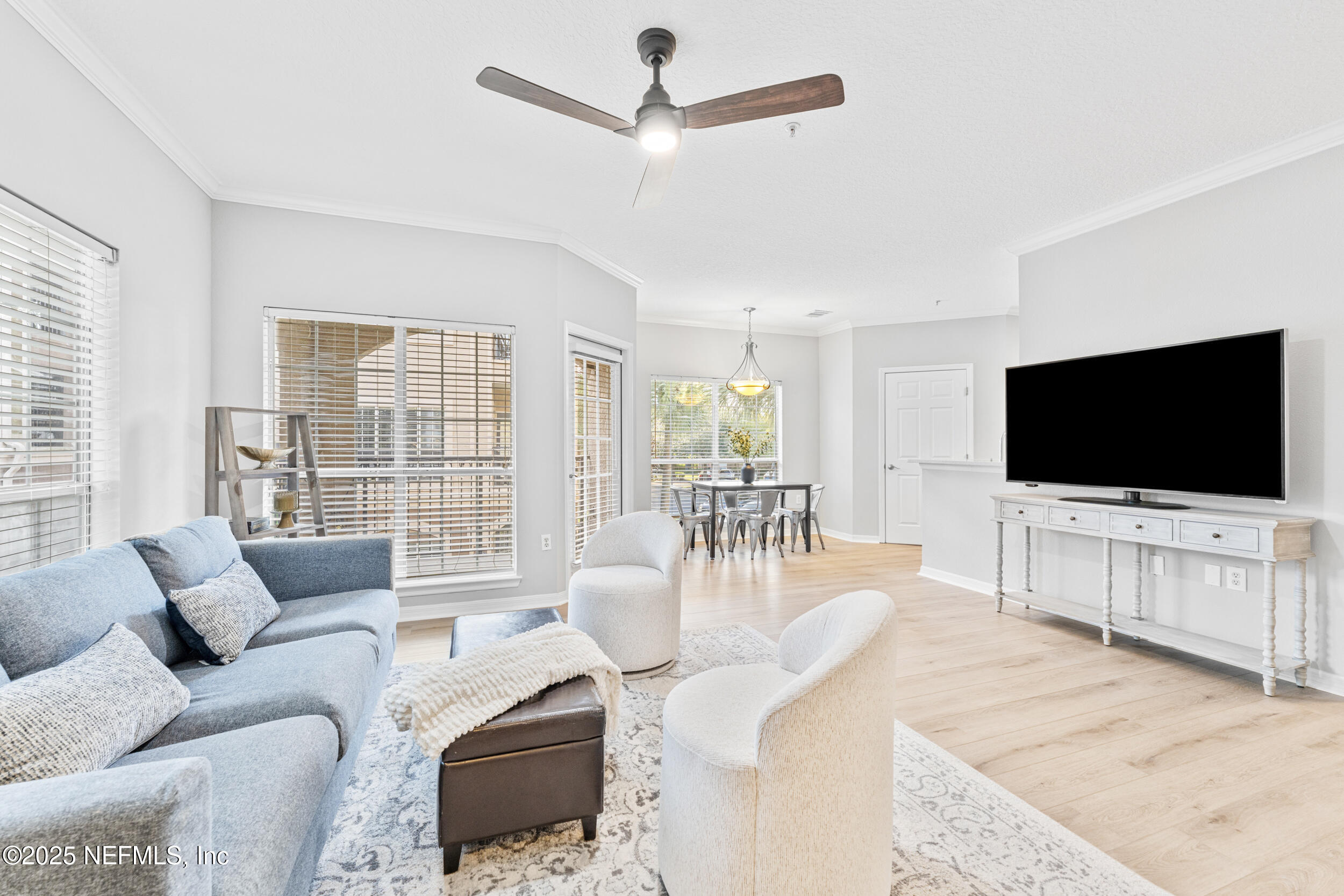 10961 Burnt Mill Road, Unit 621 Jacksonville, FL 32256 - Photo 5 of 19 a living room with furniture and a flat screen tv