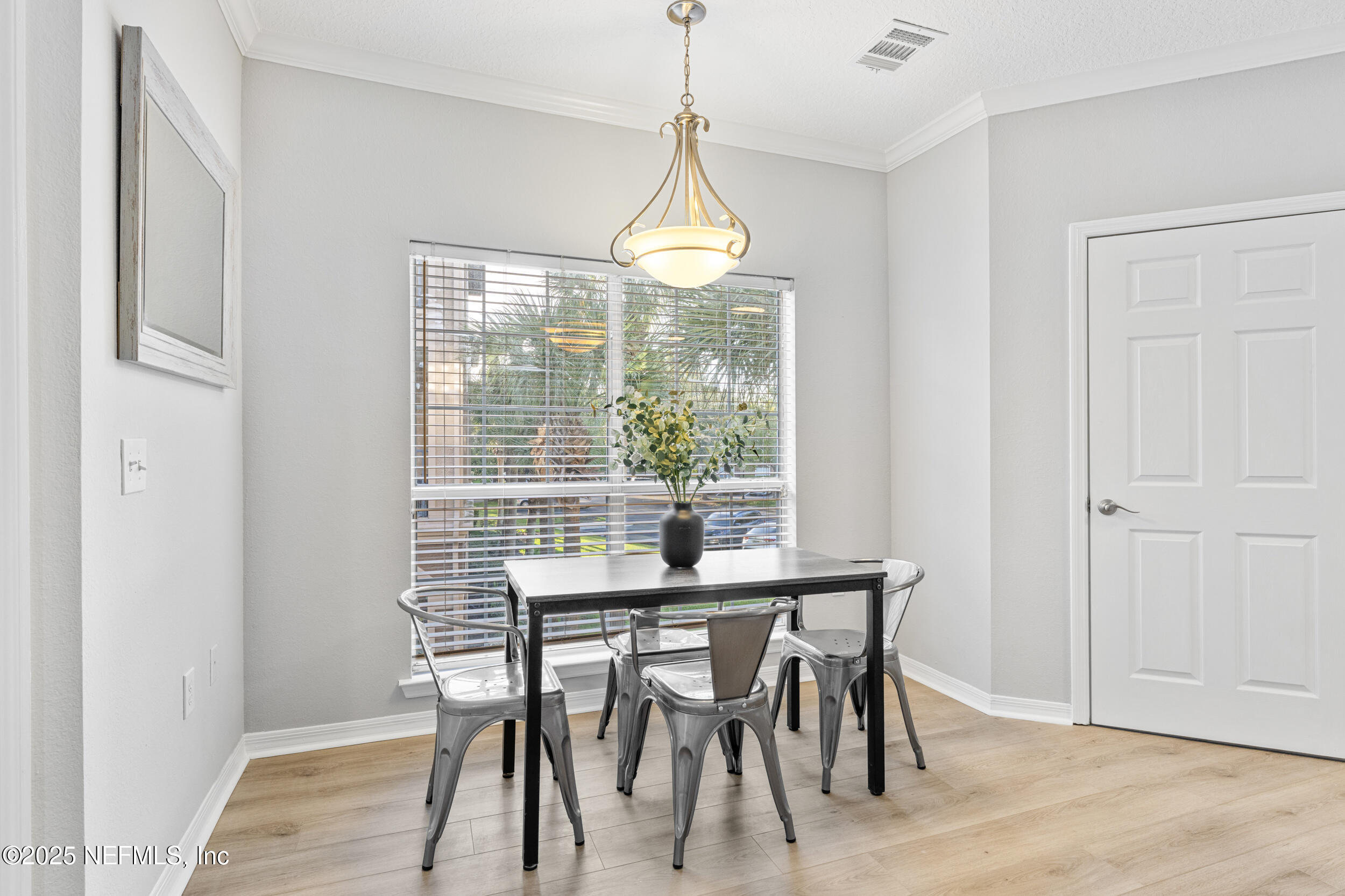 10961 Burnt Mill Road, Unit 621 Jacksonville, FL 32256 - Photo 7 of 19 a dining room with furniture window wooden floor