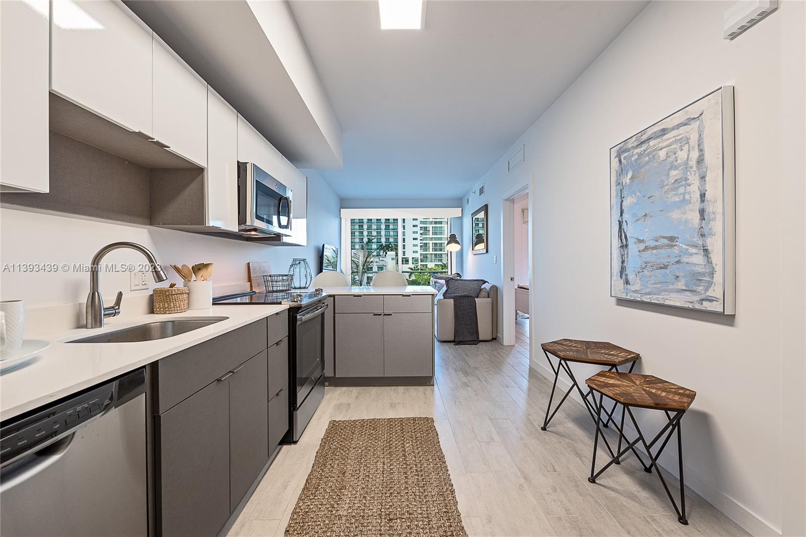 Edgewater Miami, FL 33137 - Photo 6 of 10 a kitchen with stainless steel appliances granite countertop a sink stove and cabinets