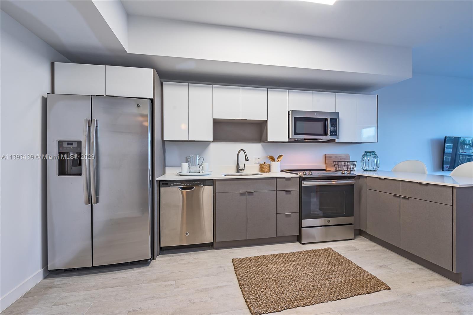 Edgewater Miami, FL 33137 - Photo 7 of 10 a kitchen with a refrigerator sink and microwave