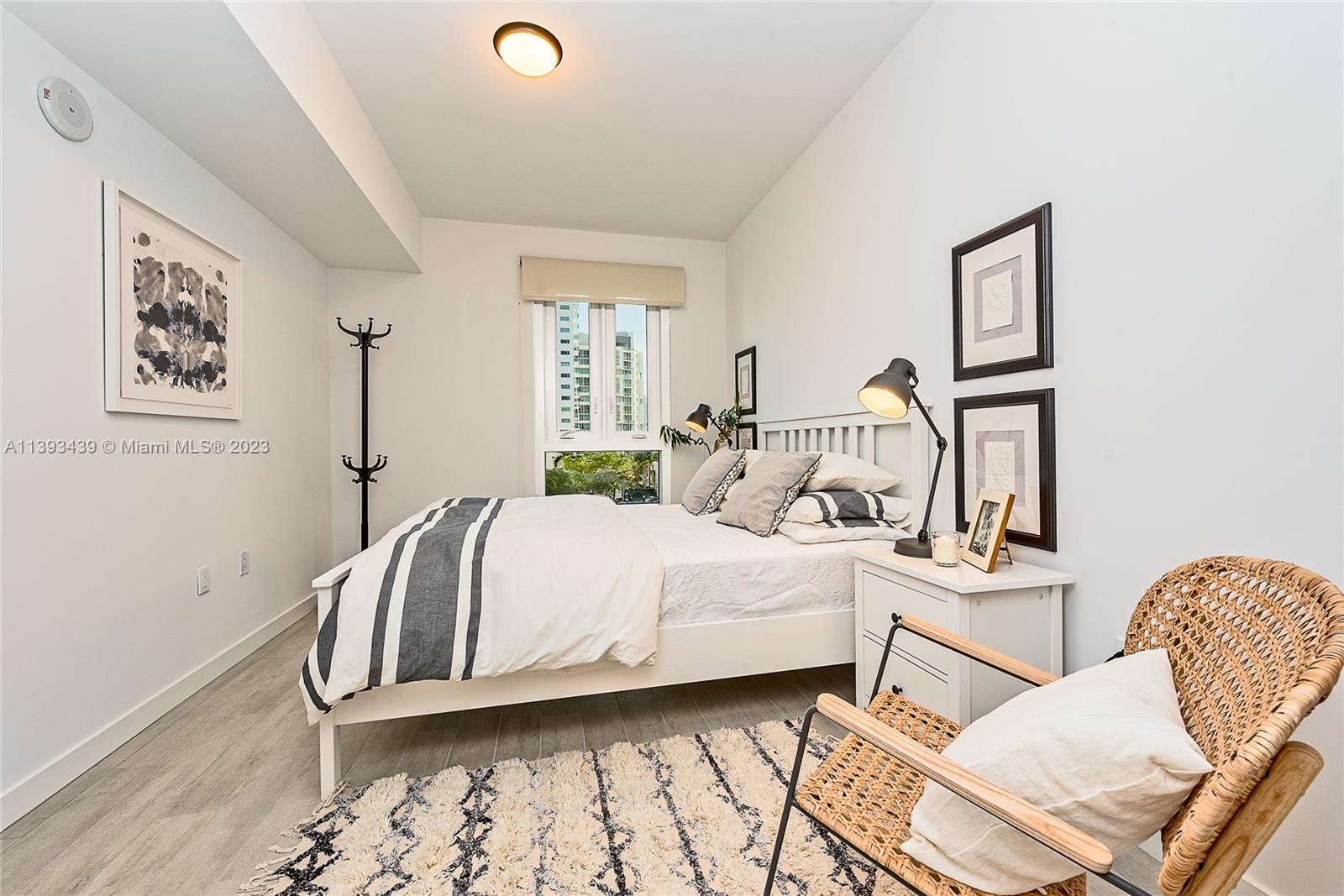 Edgewater Miami, FL 33137 - Photo 9 of 10 a bedroom with a bed and wooden floor