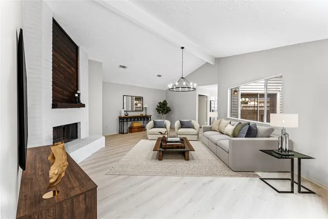 a living room with furniture or fireplace and a table
