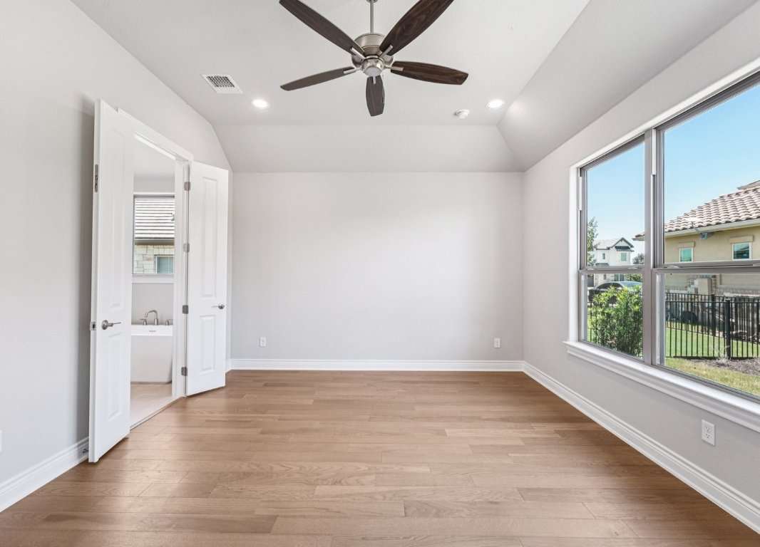 205 Indigo Lane Georgetown, TX 78628 - Photo 12 of 33 wooden floor in an empty room with a window