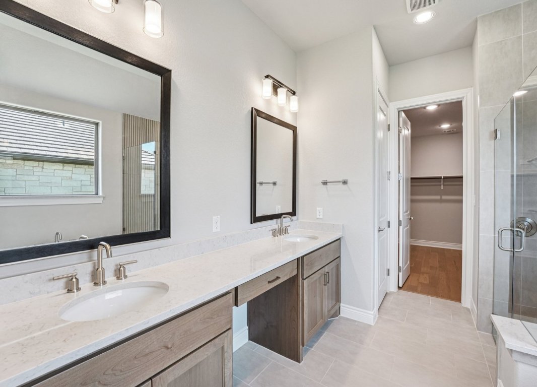 205 Indigo Lane Georgetown, TX 78628 - Photo 13 of 33 a bathroom with a double vanity sink mirror and double