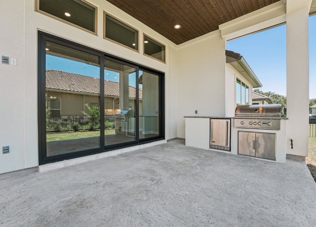 205 Indigo Lane Georgetown, TX 78628 - Photo 20 of 33 a view of an empty room with a fireplace and a large window