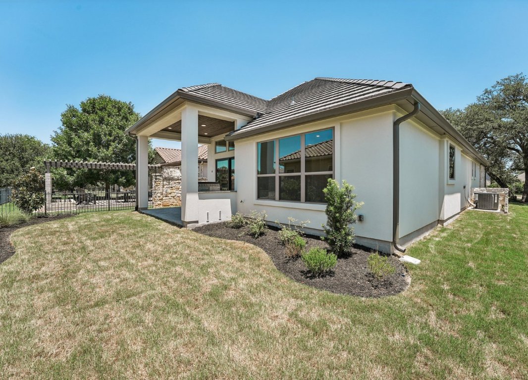 205 Indigo Lane Georgetown, TX 78628 - Photo 22 of 33 a front view of a house with a yard and garage