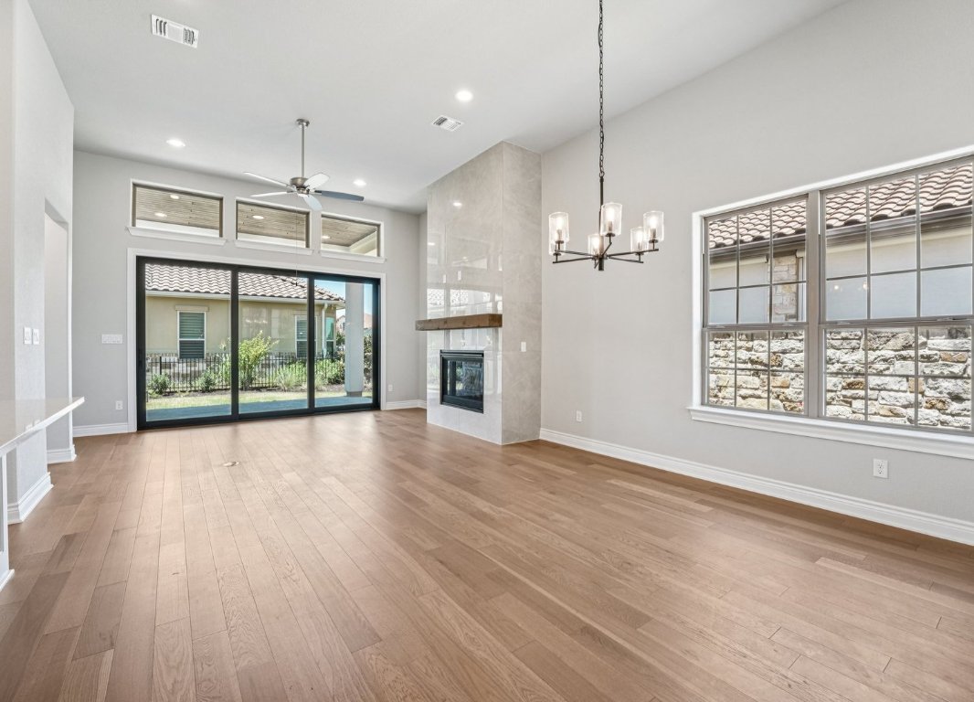 205 Indigo Lane Georgetown, TX 78628 - Photo 4 of 33 a view of an empty room with wooden floor and a window