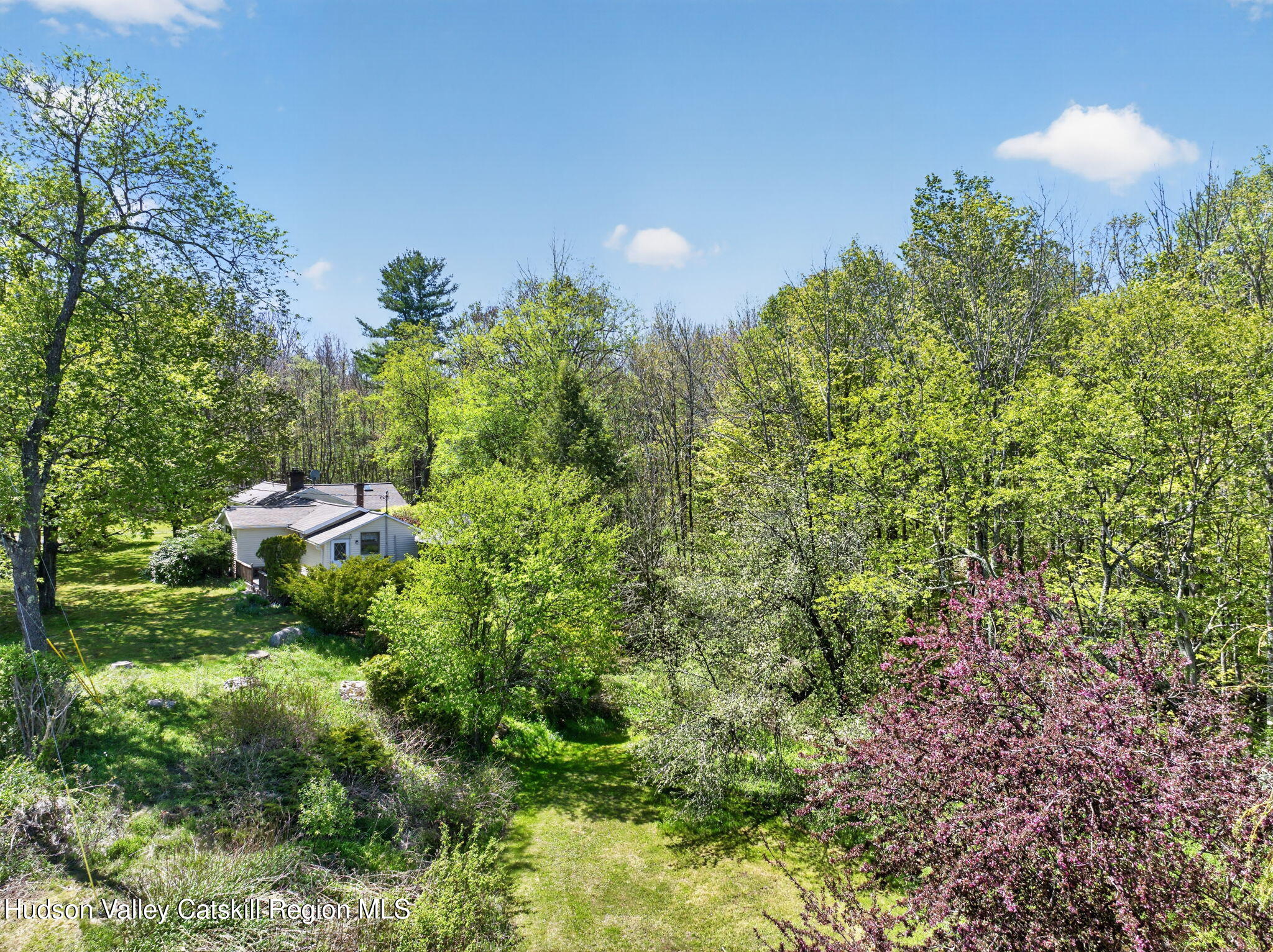 689 Old Road Windham, NY 12496 - Photo 38 of 42 a backyard with table and chairs and potted plants
