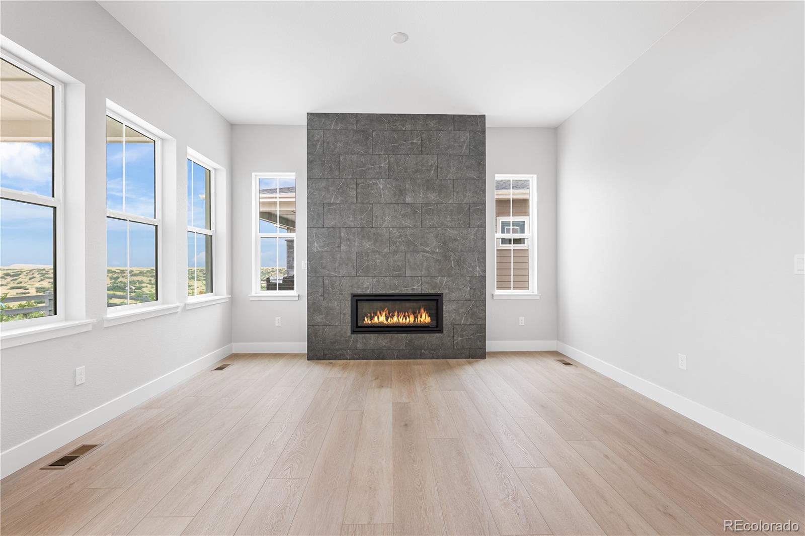 7317 Timberstone Street Castle Pines, CO 80108 - Photo 14 of 49 a view of an empty room with a window and fireplace