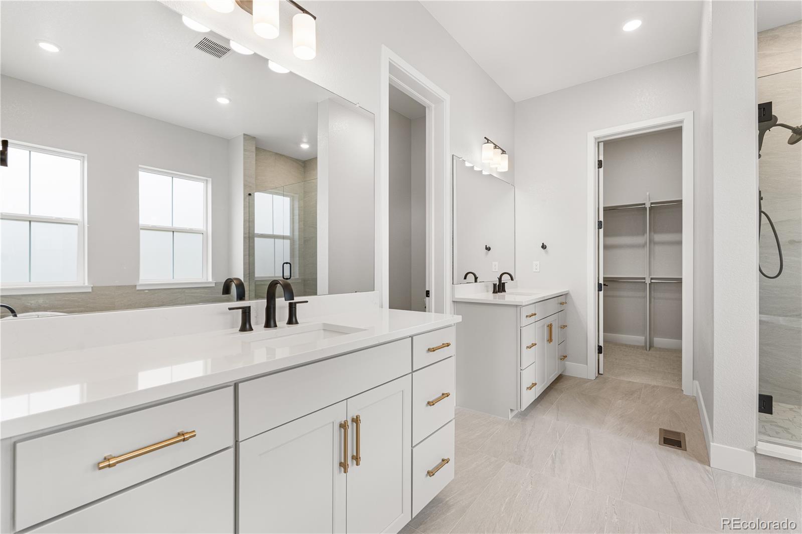 7317 Timberstone Street Castle Pines, CO 80108 - Photo 34 of 49 a spacious bathroom with a double vanity sink mirror and double