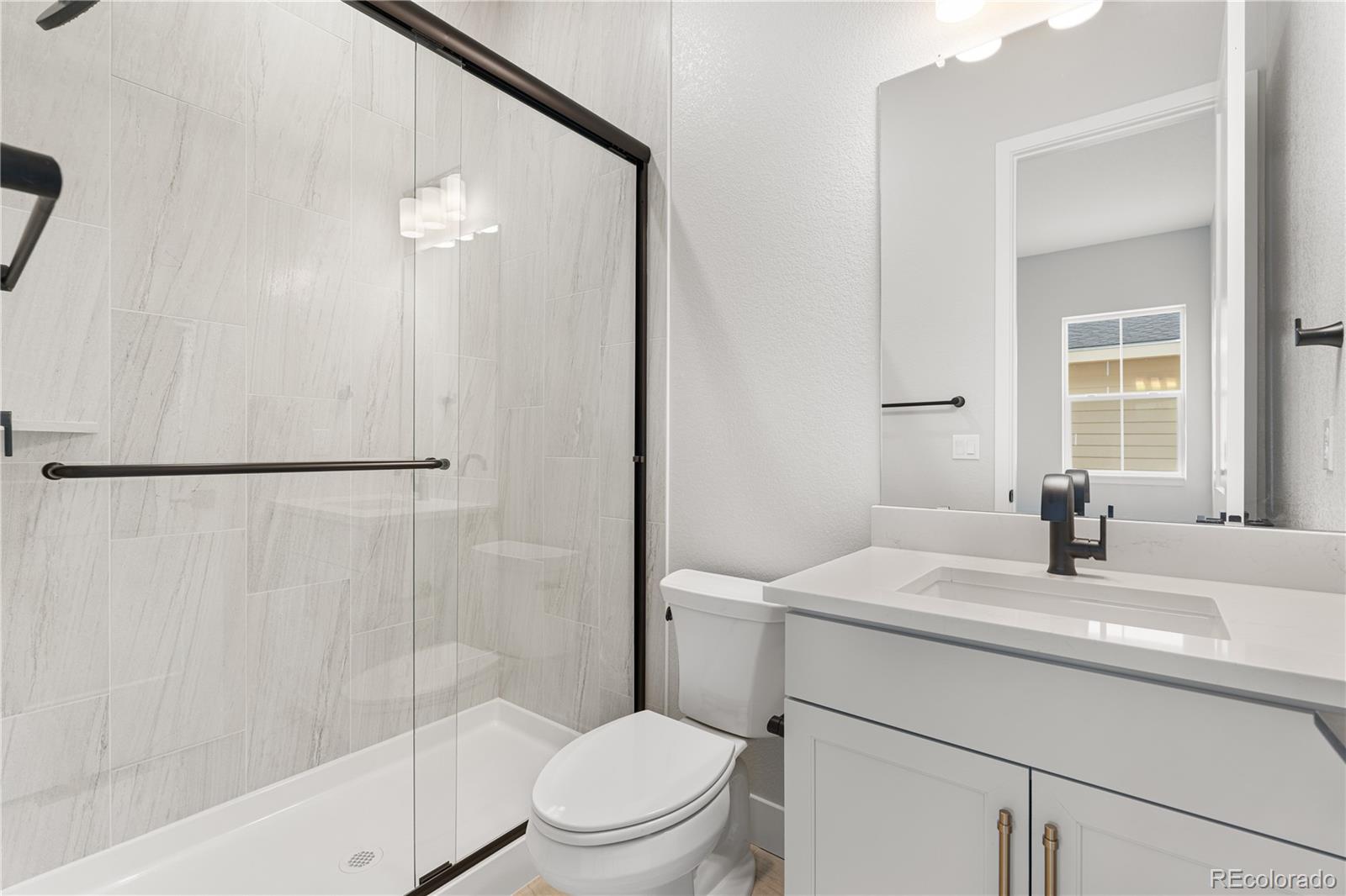 7317 Timberstone Street Castle Pines, CO 80108 - Photo 43 of 49 a bathroom with a sink toilet vanity and shower