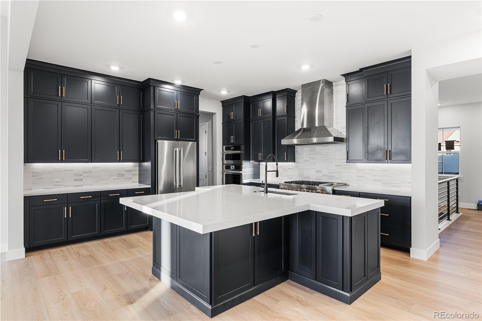 7317 Timberstone Street Castle Pines, CO 80108 - Photo 5 of 49 a kitchen with stainless steel appliances granite countertop a sink stove and refrigerator