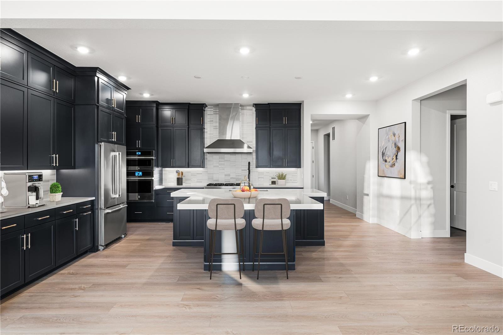 7317 Timberstone Street Castle Pines, CO 80108 - Photo 8 of 49 a kitchen with kitchen island stainless steel appliances a sink cabinets and wooden floor