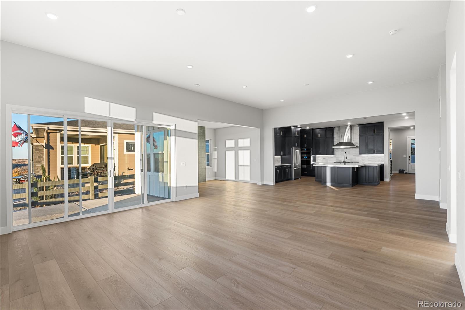 7317 Timberstone Street Castle Pines, CO 80108 - Photo 9 of 49 a view of kitchen with furniture and wooden floor